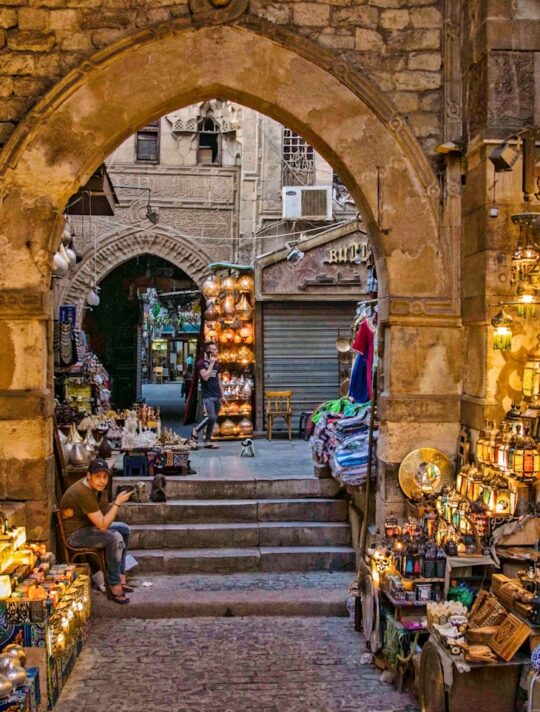 a narrow alley way with a lot of items on display